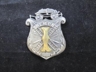 Badge on block in envelope: Tremont