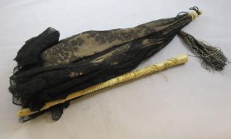 Parasol: black and tan w/carved handle and tassel