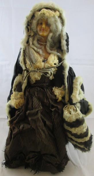 Doll: woman w/fur trimmed cape and muff on stand
