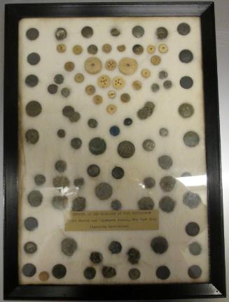 Framed set of buttons and sleeve-links (89) excavated at Fort Washington