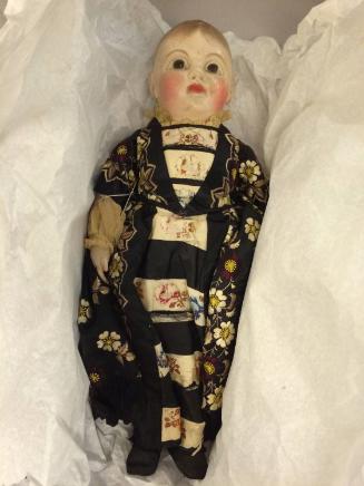 Doll: baby in black embroidered dress