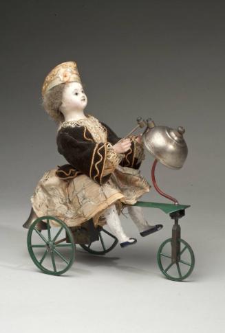 Girl on a velocipede windup toy