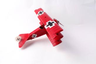 German WWII Biplane. Red and black. Iron crosses on wings and side.