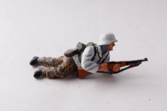 WWII German Army Waffen SS winter soldier lying prone and firing